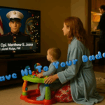 Abby Light kneels beside her baby son Teddy, who sits in a colorful play saucer and watches a USO video message from Corporal Matthew S. Jozsa on the television. Matt appears in his Marine dress blues with his name and hometown displayed on screen, while text across the image reads, “Wave Hi To Your Daddy.”